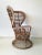 This rattan high back chair is in a very good condition. It is not marked.