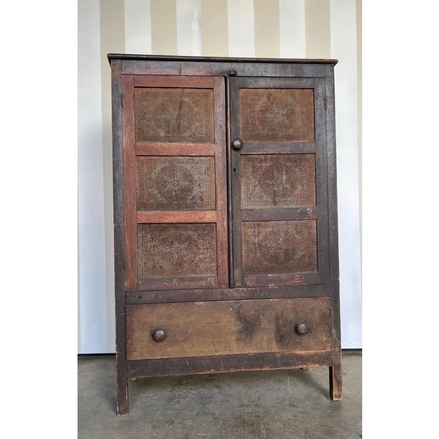 19th-century Virginia Walnut Pie Safe with Original Star Punched Tins in as-found condition. One door has been cleaned,...