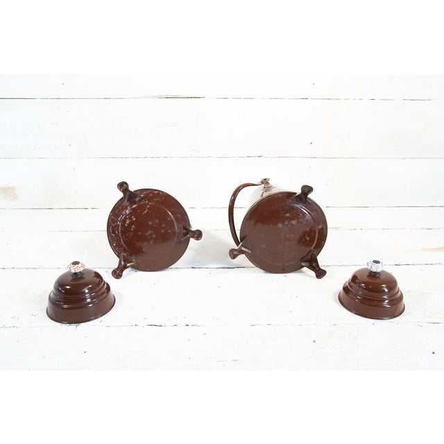 This pair of jugs contained water to put out fires in houses in the early 1900s in Holland. Almost identical in shape and...