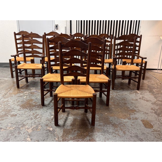 Design Plus Gallery presents a Set of Twelve Ladder-Back Dining Chairs from Collection Reproductions. The wooden frames...