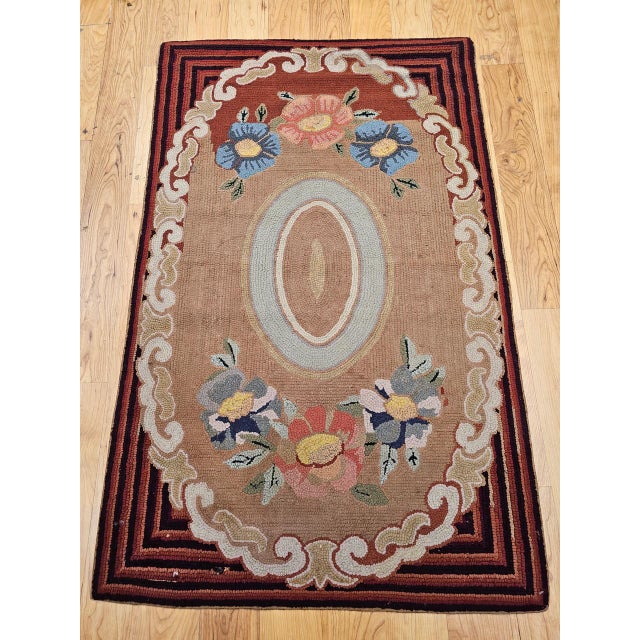 This charming early 20th-century American hand-hooked rug exemplifies the warmth, artistry, and folk traditions of New...