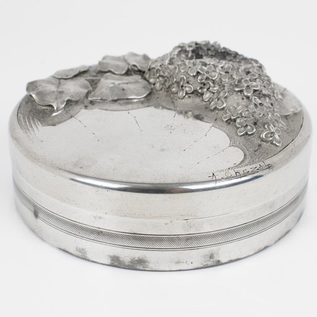 Albert Chezal designed this stunning Art Nouveau, distinctly illustrated, dinanderie-pewter-covered box, handcrafted in...