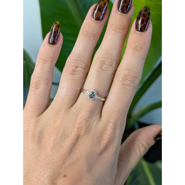 A natural color-change alexandrite glows at the center of this solid 14K yellow gold ring, surrounded by eighteen earth-...