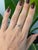 A natural color-change alexandrite glows at the center of this solid 14K yellow gold ring, surrounded by eighteen earth-...