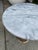 Vintage side table with a round marble top and pierced brass pedestal base. Suitable for use as a side table or accent...