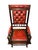 English platform rocking chair upholstered in deep button-tufted oxblood leather in the Chesterfield tradition. Solid...