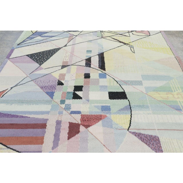 Hand-knotted in wool circa 1980, this 8x13 vintage rug is a compelling example of late 20th-century European design,...