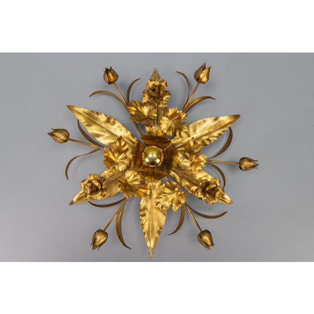 Gilt metal flower-shaped flush mount or wall lamp, the 1970s. Adorable Hollywood Regency style gilt metal flower-shaped...