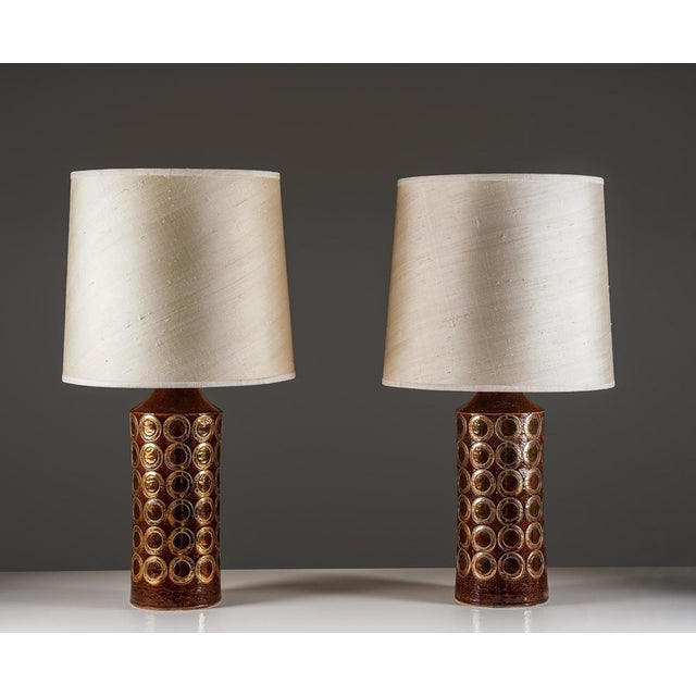 Striking pair of 1970s table lamps featuring ceramic bases produced by bitossi and assembled as lamps by miranda in...