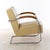 Chrome-plated steel tubing. Upholstered and covered in beige leather. Stained wooden armrests, hand-polished with shellac....