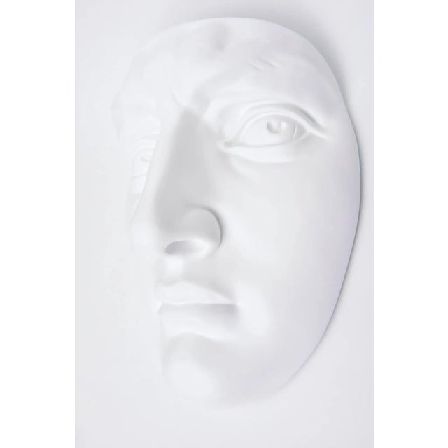 This vintage 1960s white painted resin and plaster of Paris face wall sculpture is from a company in Chicago. It is marked...