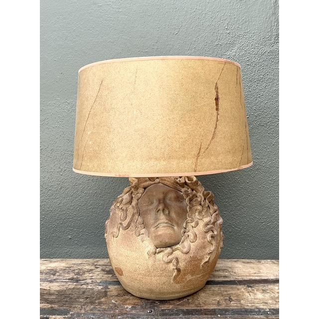This captivating vintage table lamp is a masterwork of surrealist studio pottery, featuring hand-sculpted faces that...