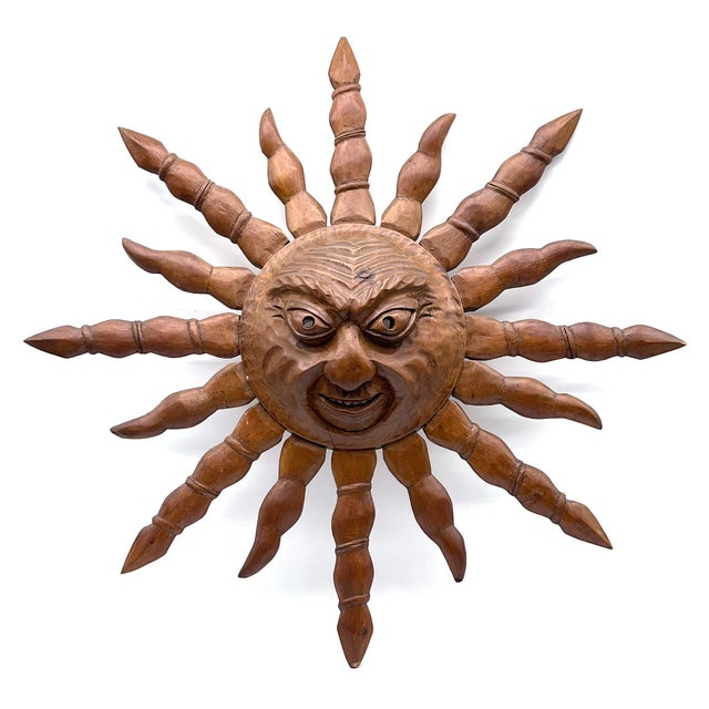 Expressive, hand-carved sun face wall mask made of solid wood, carved by the renowned Hermann Reichegger. The sculpted sun...