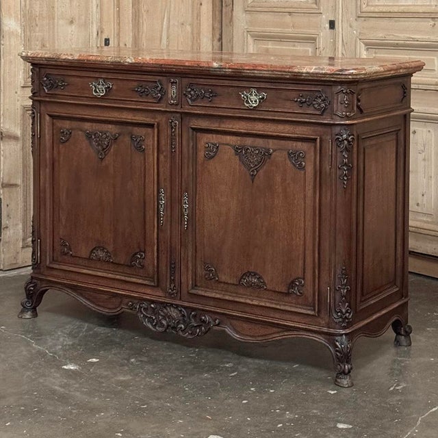Antique Country French Louis XIV Walnut Marble Top Buffet represents the sophisticated side of the genre, executed in...