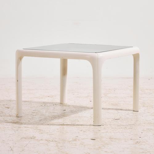 Wooden coffee table with rounded details and smoked glass top from the 1970s. with some surface scratches, stains and wear...