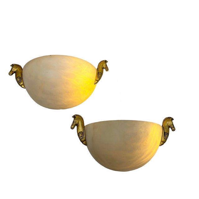 A rare set of very atmospheric wall lamps of Alabaster with decoration of horse heads. Made in the 50-60s in Art Deco...