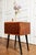 Vintage teak veneer side table on black lacquered tapered legs. This piece is in excellent vintage condition with only...