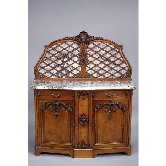 This imposing and beautiful pair of sideboards is part of a rare and important Regency-style dining room set in molded and...