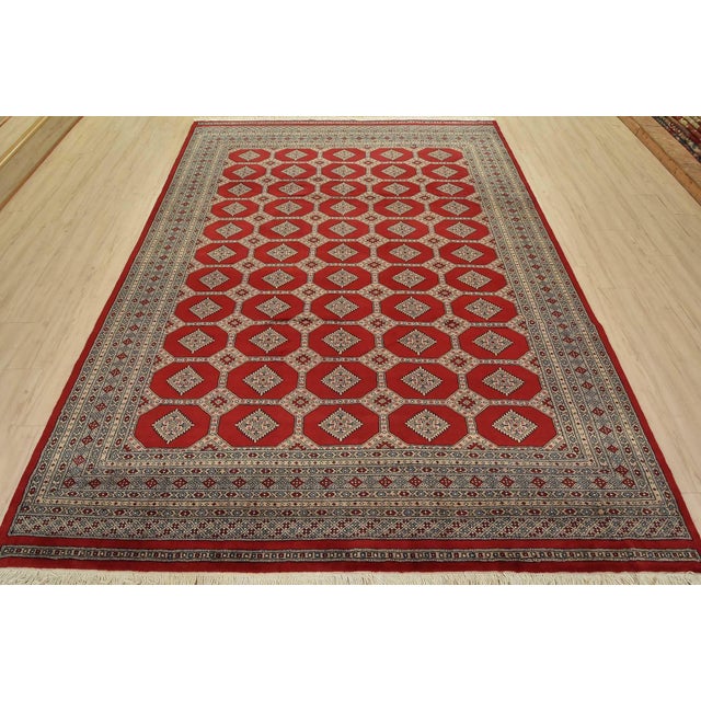 A tribal Bokhara Jaldar rug hand-knotted with fine wool on a cotton foundation. This rug features rows of repeating...
