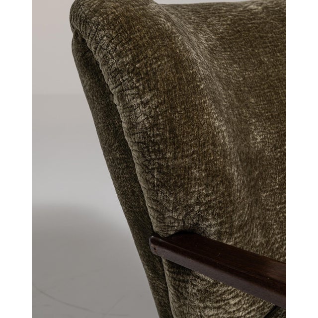 A green wood, Mid-Century Modern-style armchair, dating to the 1940s and made in Denmark. The wood frame is finished in...