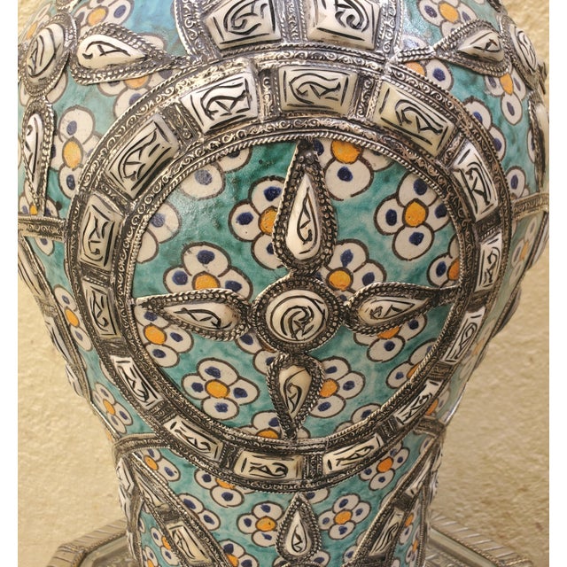 Made in Fez, Morocco, this incredible hand painted metal vase is adorned with resin dots, giving it a very exotic look,...