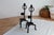 Black metal candlesticks, crafted in a brutalist style with twisted iron supports, decorative rings, and a graphic...