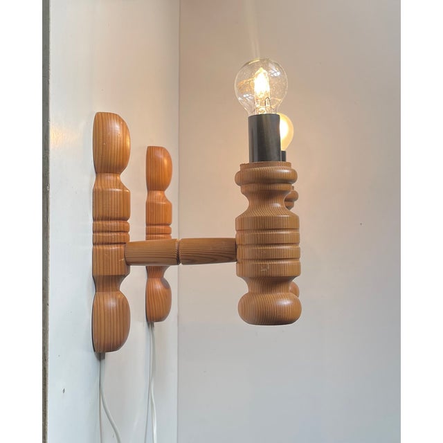 A set of 2 wall lamps fashioned from engine turned oregon pine. Designed and made in-house by hs belysning in denmark...