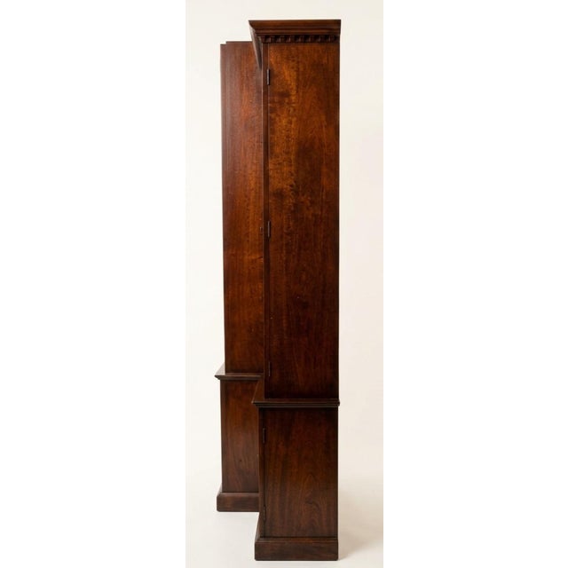 This George III Mahogany Breakfront Cabinet is an imposing, multi-functional piece of English case furniture dating back...