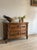 A 17th-century French walnut commode of two long drawers, the fronts worked in shaped, molded panels around central...