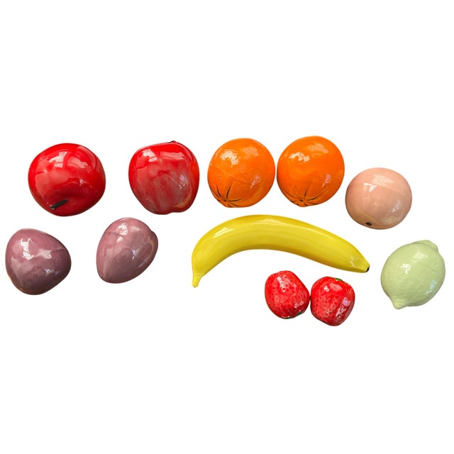 A vibrant and highly collectible set of vintage Italian life-size ceramic fruits, hand-painted in rich, saturated glazes...