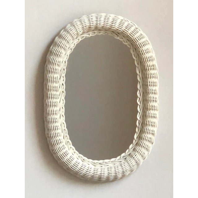 Offering a lovely vintage wicker wall mirror finished in a soft ivory. The wide wicker frame has a sturdy wood backing....