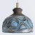 Stunning round hanging lamp with an unusual shape, made with rich brown and light blue colored ceramics, manufactured in...