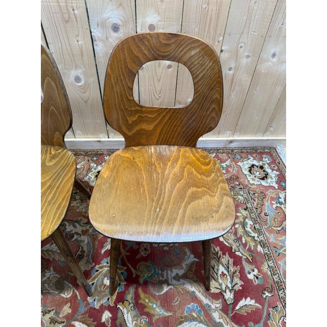 Set of four Baumann dining chairs, "eye" model. These Scandinavian design chairs from the 1950s feature a characteristic...