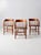 A set of three antique early 20th-century wood captain’s chairs with gently curved low backs, gracefully bentwood arms,...