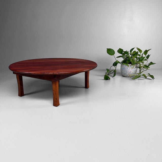 A low Japanese table with a warm wooden top and a simple, balanced form. Dimensions: height 26 cm, diameter 71 cm. A...