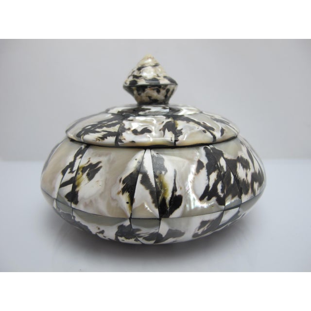 Pretty little lidded box for simple storage of your trinkets or jewelry items. Round wood box inlaid with black and white...