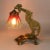 Textured table lamp in modern style, made of bronze, with a glass lampshade. 1900. The leg of the lamp is represented by a...