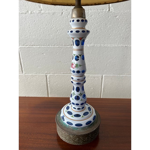 Bohemian blue glass lamp with white overlay and painted rose detail. Patina on bases as shown. Slender design making this...
