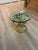 A striking example of 1960s Hollywood Regency design, this vintage side table features a sculptural gilded metal base...