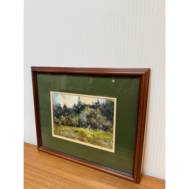 Design Plus Gallery presents a Wood Framed Landscape Watercolor. The piece has a thick green matte with an artwork showing...
