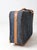 This vintage 1980s Frequent Traveler suitcase features a tailored blue-gray tweed exterior with camel-toned trim and...