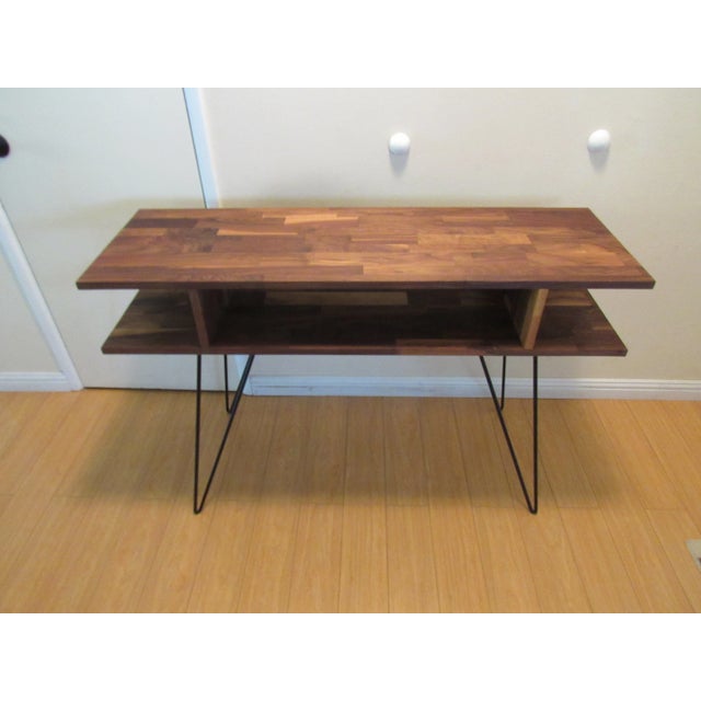 modern console or sofa table made of solid American black walnut with a natural hand-rubbed oil finish. It uses an eco-...