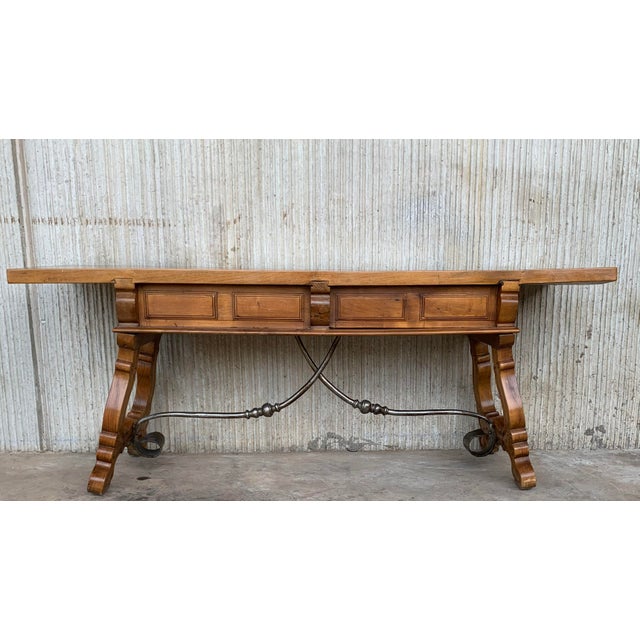 19th century Spanish bench or low console table with carved lye legs in two side of both legs. Original iron pull hardware...