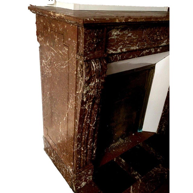 Louis xvi style fireplace in speckled red marble two curved jambs with recessed fluting and carved acanthus leaves flushed...
