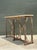 This vintage console table beautifully combines the enduring strength of patinated metal with the refined elegance of a...