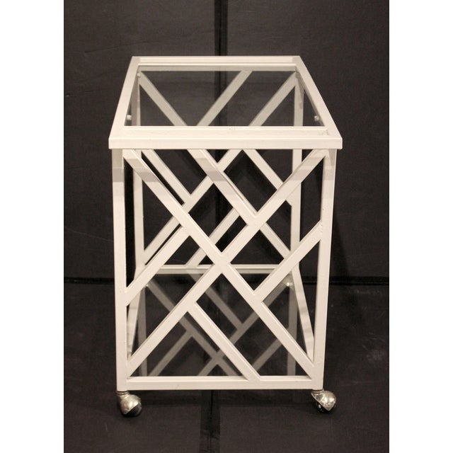 Circa 1970 Mid Century Modern Iron & Glass Bar Cart, American. Smartly styled Asiatic lattice design of tubular iron &...
