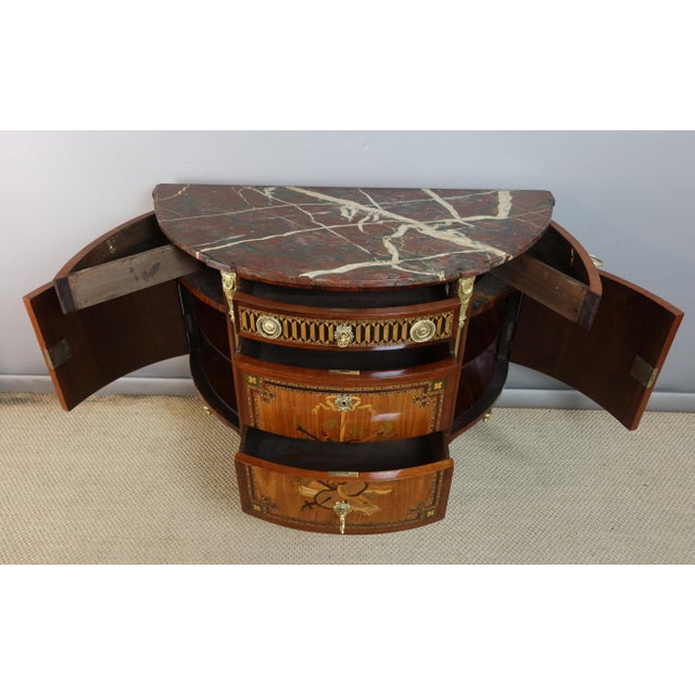 "half-moon commode with musical inscriptions" a louis xvi style half-moon commode with musical inscriptions, opening with...