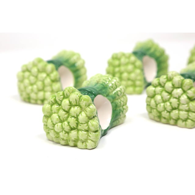 A set of six vintage ceramic napkin rings, in the form of bundles of asparagus.