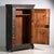 This antique painted wardrobe in pine wood is a Central European peasant wardrobe with a single door, polychrome floral...