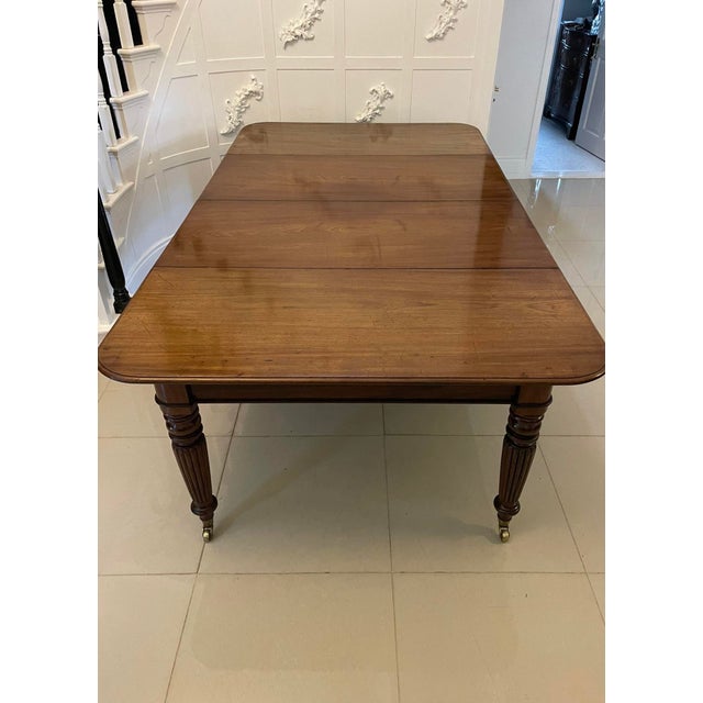 Outstanding quality antique Regency mahogany 10/12 seater extending dining table having a marvellous quality figured...